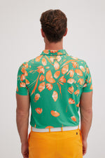 Botanica Golf Polo in Apricot Orange on Mint Green
